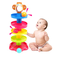 Baby playing with colorful stackable rolling ball toy, enhancing motor skills and coordination through interactive play.