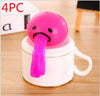 Pink vomiting toy with a long tongue on top of a white cup, stress relief and prank gift.