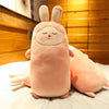 Plush rabbit pillow with cute squinting smile and soft pink fabric, perfect for cuddling and home decor.