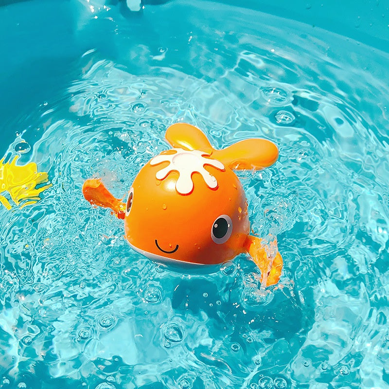 Orange clockwork floating bath toy in water, designed as a cute animal, perfect for kids' water play and bath time fun.