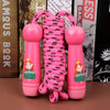 Wooden skipping rope for kids with pink cartoon handles and adjustable rope, perfect fitness toy for active play and exercise.