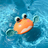 Cute orange crab bath toy floating in water for kids' playtime fun.