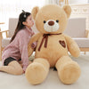 Woman cuddling with plush teddy bear featuring ribbon and heart design, ideal for gifting and snuggling.