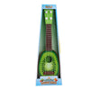 Retro children's toy ukulele in green with realistic design, packaged in a colorful box for musical play and creativity.