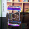 Creative quicksand liquid hourglass ornament on desk, modern resin décor piece, elegant fluid motion for home or office.