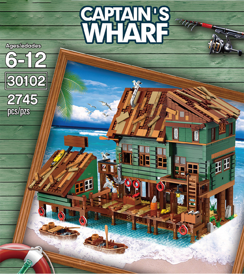 "Captain's Wharf Building Block Set with fishing house design on beach backdrop, ideal for creative play and imagination."