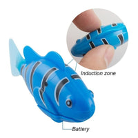 Blue electronic swimming robot fish toy with battery and induction zone highlighted in close-up.