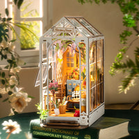 DIY Garden House Book Nook Kit with intricate mini garden design on bookshelf. Perfect bookshelf insert for decoration.