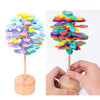 Colorful wooden rotating lollipop toy with spiral design for stress relief and creativity on desk.