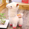 Cute alpaca llama plush toy with vibrant colors, fluffy texture, and charming design on a wooden table, perfect for gifting or decor.