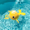 Yellow clockwork bath toy swimming in water, with cute animal design for kids' playtime fun in baths and pools.