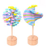 Wooden rotating lollipop toy with colorful spiral design for stress relief and relaxation, inspired by Fibonacci sequence.