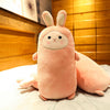 Plush rabbit pillow with cute facial expression and soft fabric on bed.