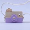 Wooden toy camera with a pivotable lens in purple, designed for kids' pretend play and educational role-playing activities.