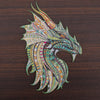 DIY wooden puzzle dragon design on dark wood surface, showcasing colorful intricate patterns. Perfect for creativity and unique gifts.