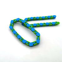 Blue and green bike chain fidget toy for stress relief and focus improvement, in a looped shape on white background.