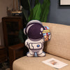 Plush astronaut rocket pillow on a sofa, space-themed stuffed toy for kids and gifts, made of soft plush fabric.