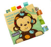 Soft baby cloth book featuring a colorful monkey design with various fabric tags for interactive learning and sensory play.