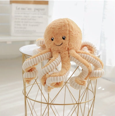 Cute baby octopus plush toy on a modern table, perfect for kids' cuddles and nursery décor.