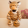 Jungle animal plush tiger toy with soft stripes sitting on a beige surface, ideal for cuddling and decoration.