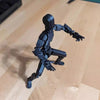 Movable shapeshift robot 2.0 in dynamic pose on wooden surface, 3D-printed action model toy for creativity and fun.