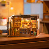 Miniature bakery dollhouse with detailed wooden interior, baked goods, and decorative elements from Rolife Becka's Baking House DIY kit.