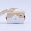 Wooden toy camera for kids with pivotable lens, natural wood finish, and white accents; perfect for pretend play and creativity.