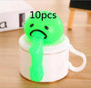 Green vomiting stress relief toy with slime, set of 10 on white background.