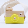 Wooden toy camera with yellow details and strap, designed for kids' pretend play and creativity. Eco-friendly and safe for toddlers.