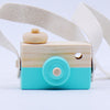 Wooden toy camera with blue and natural wood finish, featuring a pivotable lens and strap for pretend play. Perfect educational toy for kids.