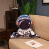 Plush astronaut pillow with DJ theme on sofa, space-themed decor for kids and gifts.