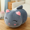 Soft plush fat cat doll in gray with pink ears on a wooden table, perfect for cuddling and decor.