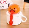 Funny vomiting egg yolk toy for stress relief and pranks on a cup, perfect quirky gift for kids and adults.