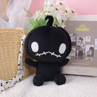 Black Halloween plush pumpkin doll with cute face, ideal for holiday décor or gifting, shown in cozy room setting.