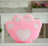 Soft pink plush pillow shaped like a paw with heart detail, perfect for decoration or a cozy gift.