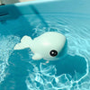 Blue whale clockwork bath toy floating in a pool, designed for kids' interactive water play and swimming fun.