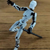 Movable shapeshift robot 3D-printed action model with flexible joints posing dynamically on a wooden surface.