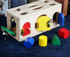 Wooden shape sorting lock box with colorful shapes, promoting preschool kids' cognitive development and problem-solving skills.