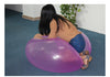 Child playing with a purple inflatable bubble balloon toy indoors.