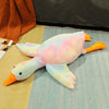 Big white goose plush pillow with colorful pattern, lying on a bed, perfect soft sleeping toy for kids and adults.