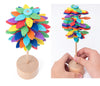 Colorful wooden rotating lollipop toy with leaf-like spirals for stress relief and desk decor.