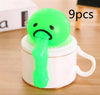 Green vomiting toy on white mug with green slime, 9 pieces set for stress relief and fun pranks.