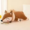 Kawaii plush fox stuffed animal soft toy doll in brown, lying on a bed, showcasing its cute design and soft texture.