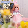 Articulated 1/6 BJD doll in pink dress with bunny ears standing among flowers, showcasing lifelike design and flexible posing.