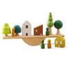 Wooden animal balance board with colorful houses and trees for Montessori stacking and threading play.