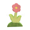 Wooden pink flower piece from kids Montessori educational toy set for pretend play and scene building.