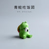 Green frog figurine holding a rice ball, 4x3x2.5cm, against a plain background.