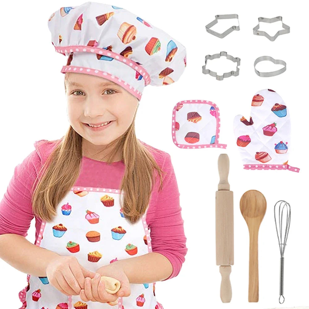 Child wearing kids chef costume with apron and hat, surrounded by baking play set tools like cookie cutters and utensils.