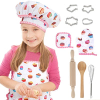 Child wearing kids chef costume with apron and hat, surrounded by baking play set tools like cookie cutters and utensils.