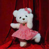 Little Bear Plush Doll in red checkered dress with bow, posed against a red backdrop, featuring soft fabric and changeable clothes.